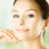 Smiling woman holding hand under chin